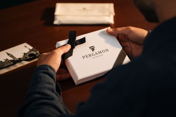 Hands holding a branded gift box