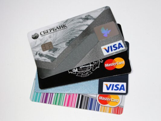 Customer tapping phone on NFC review card at business counter