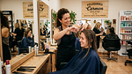 Stylist delivering a haircut in a neighbourhood salon