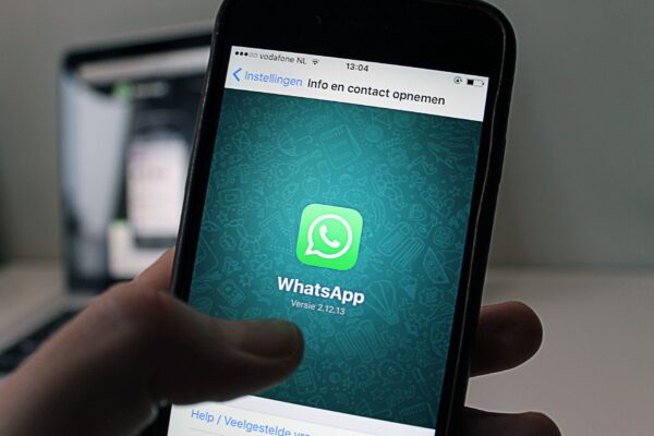 Phone showing WhatsApp Business chats for customer communication