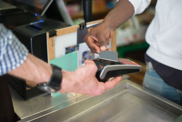 Hand tapping NFC smart card on phone to share contact profile