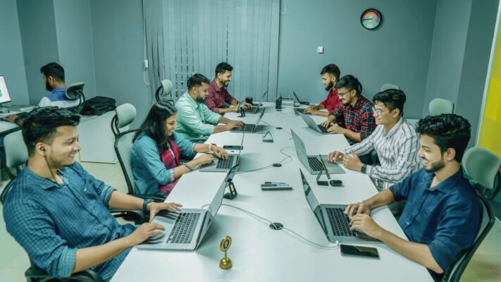 Team working on laptops around a table