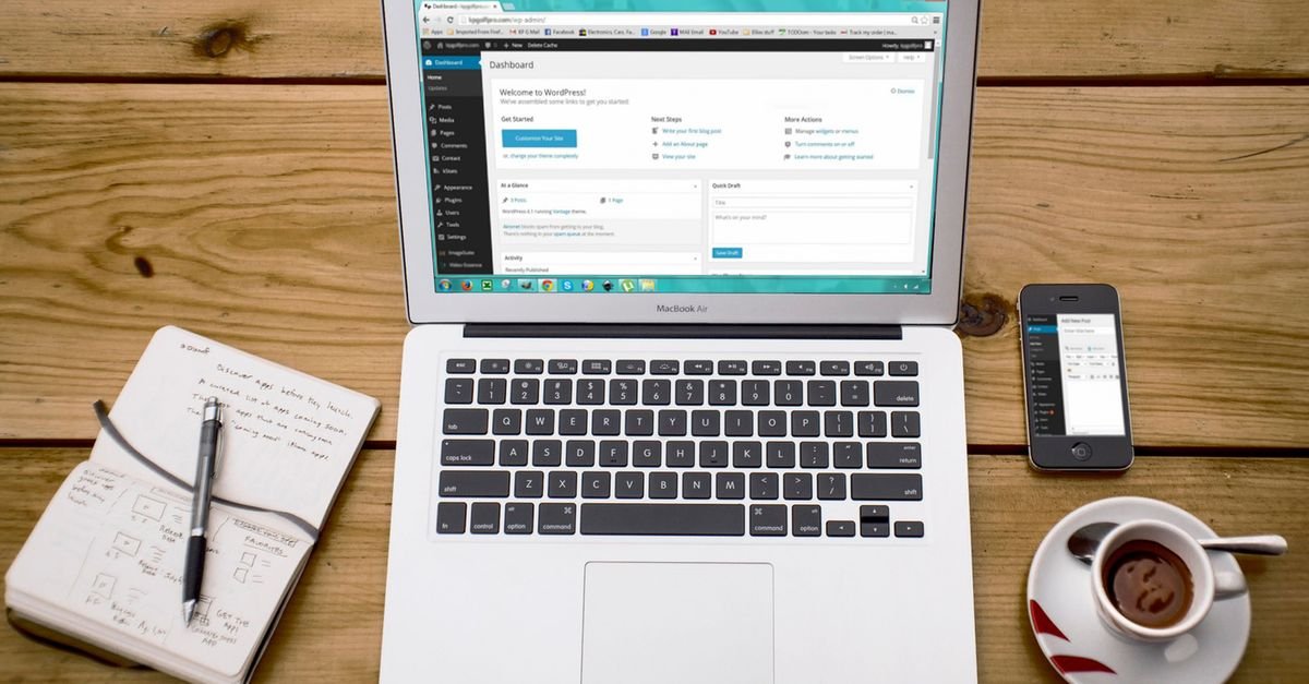 A cozy home office scene with a laptop, notebook, smartphone, and coffee, perfect for productivity