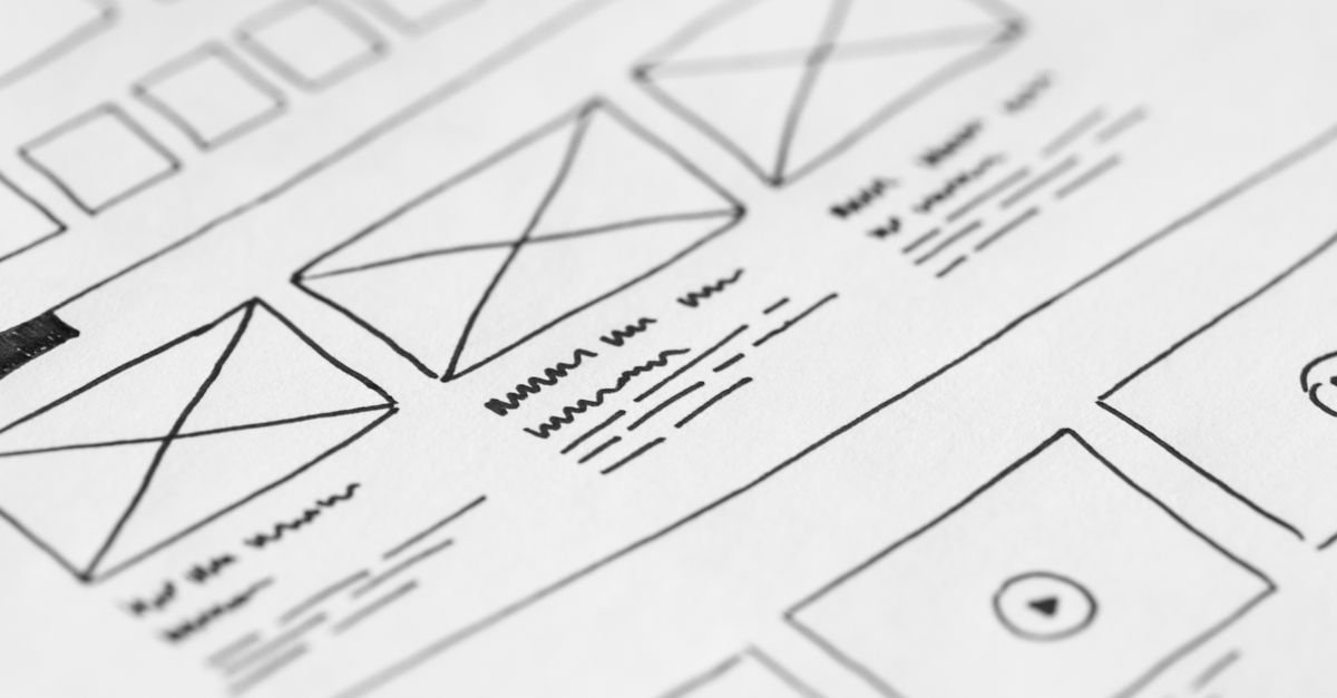 Detailed close-up of a hand-drawn wireframe design on paper for a UX project